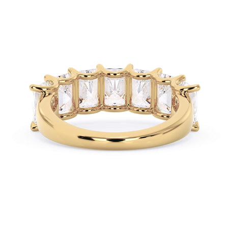 A picture of a seven stone diamond wedding ring with radiant cut diamonds that are U prong set in yellow gold on a white background with a view of the underside of the ring.