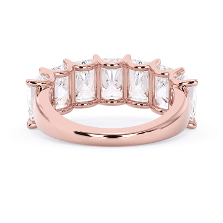 A picture of a seven stone diamond wedding ring with radiant cut diamonds that are U prong set in rose gold on a white background with a view of the underside of the ring.