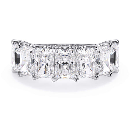 A picture of a seven stone diamond wedding ring with radiant cut diamonds that are U prong set in white gold or platinum on a white background with the ring facing forward, lying down.