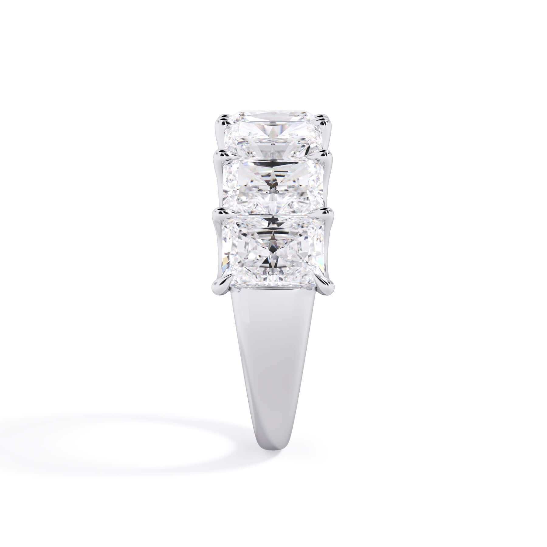 A picture of a seven stone diamond wedding ring with radiant cut diamonds that are U prong set in white gold or platinum on a white background with a side profile view.