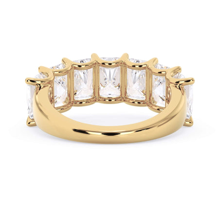 A picture of a seven stone diamond wedding ring with radiant cut diamonds that are U prong set in yellow gold on a white background with a view of the underside of the ring.
