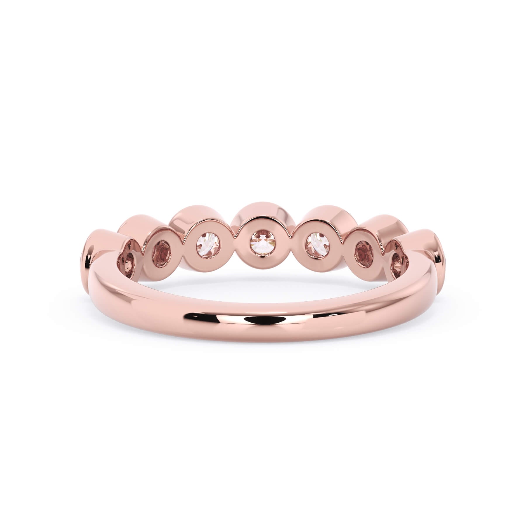A picture of a seven stone diamond wedding ring with round diamonds that are bezel set in rose gold on a white background with a view of the underside of the ring.