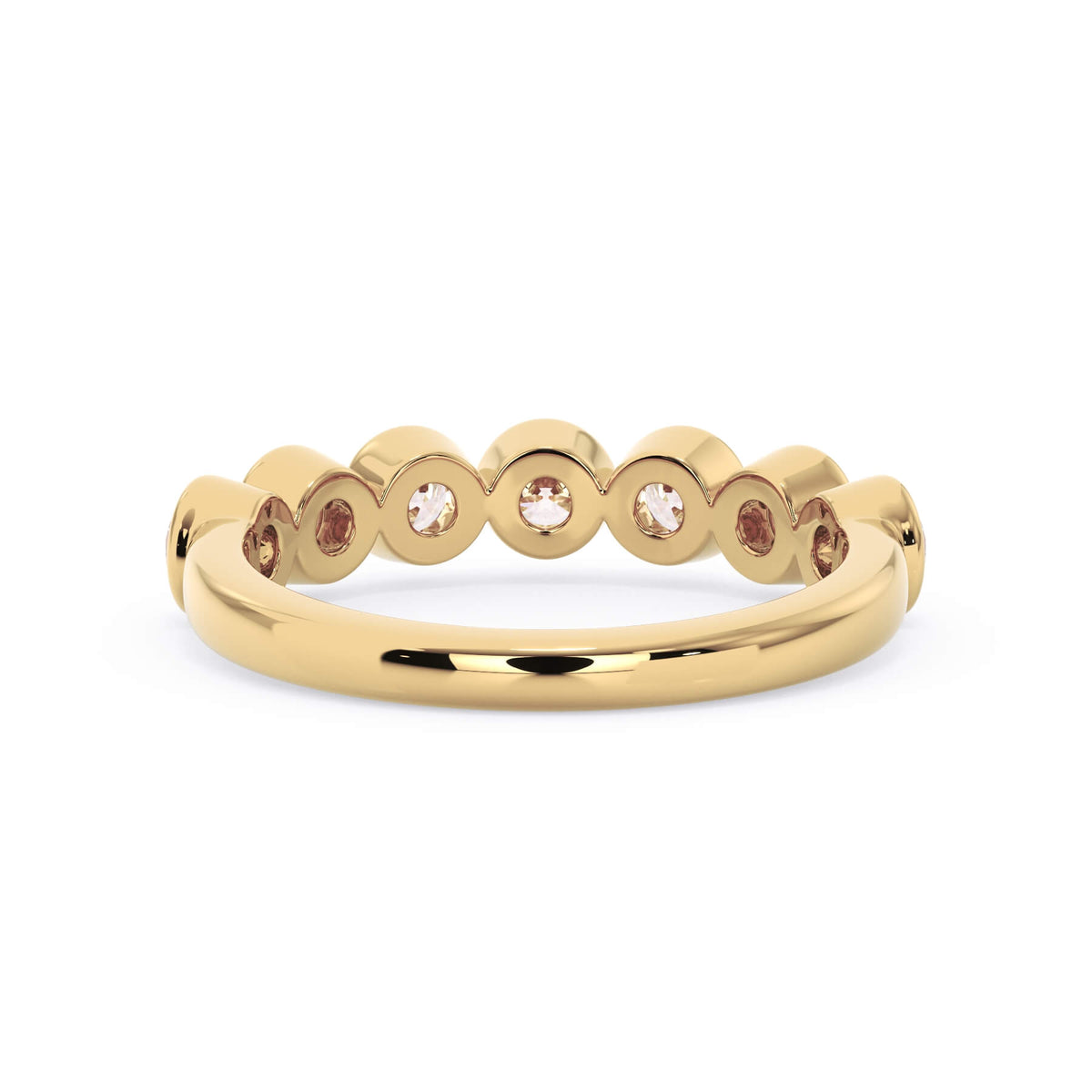 A picture of a seven stone diamond wedding ring with round diamonds that are bezel set in yellow gold on a white background with a view of the underside of the ring.