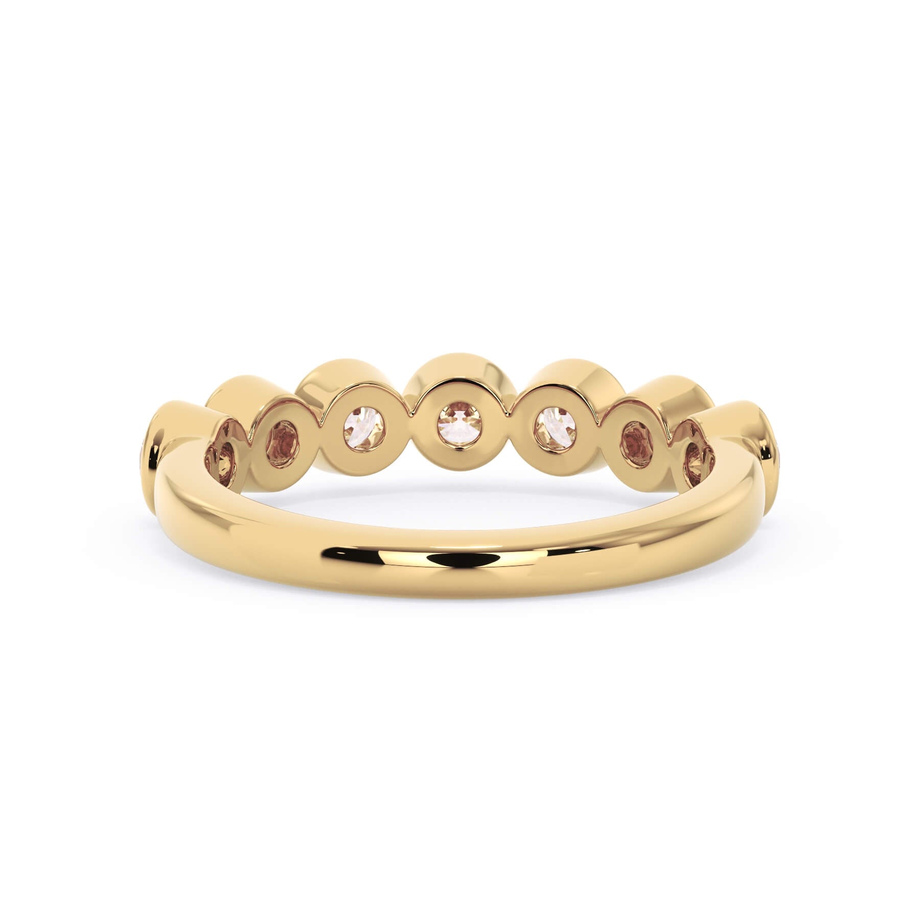 A picture of a seven stone diamond wedding ring with round diamonds that are bezel set in yellow gold on a white background with a view of the underside of the ring.