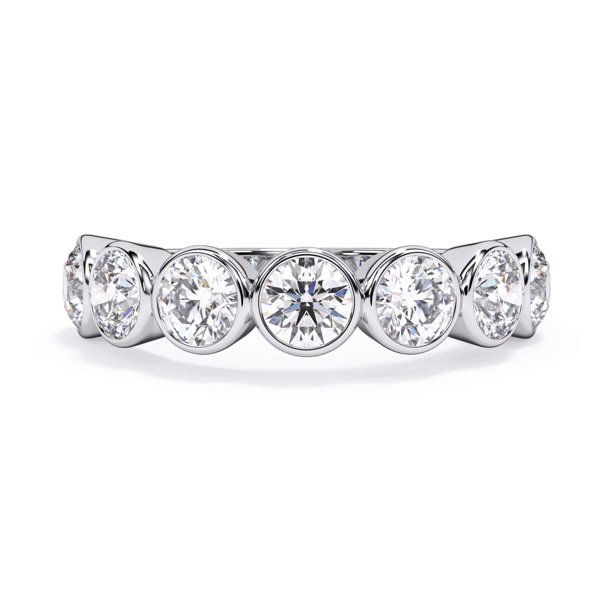 A picture of a seven stone diamond wedding ring with round diamonds that are bezel set in white gold or platinum on a white background with the ring facing forward, lying down.