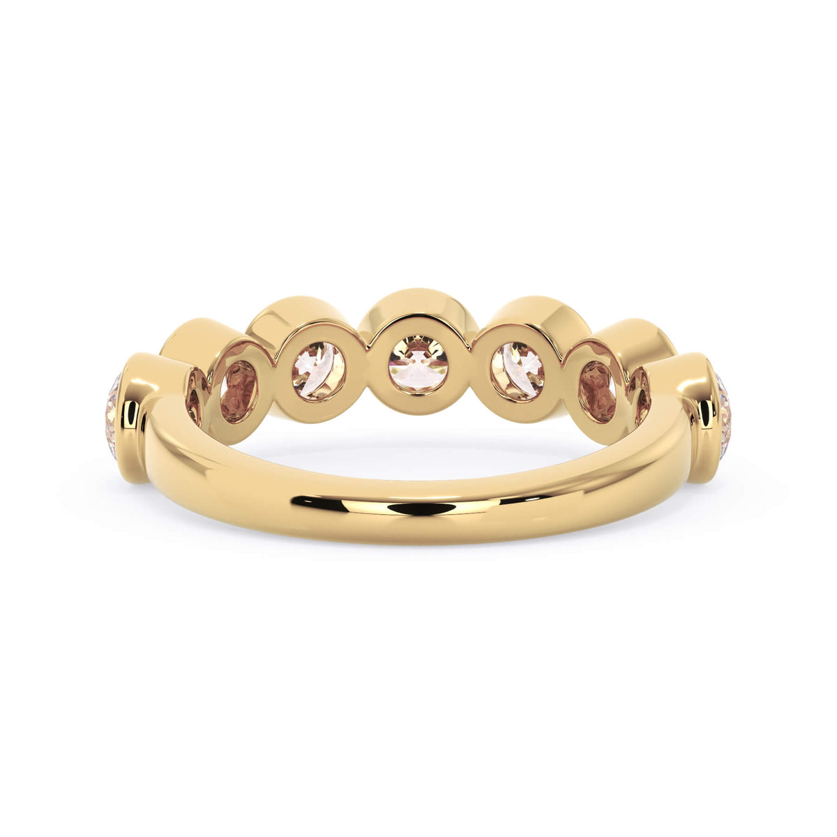 A picture of a seven stone diamond wedding ring with round diamonds that are bezel set in yellow gold on a white background with a view of the underside of the ring.