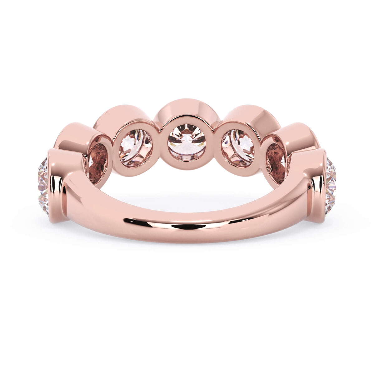 A picture of a seven stone diamond wedding ring with round diamonds that are bezel set in rose gold on a white background with a view of the underside of the ring.
