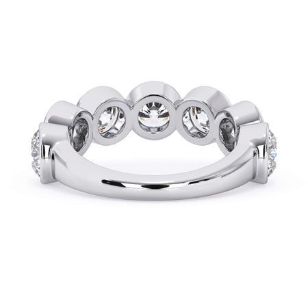 A picture of a seven stone diamond wedding ring with round diamonds that are bezel set in white gold or platinum on a white background with a view of the underside of the ring.