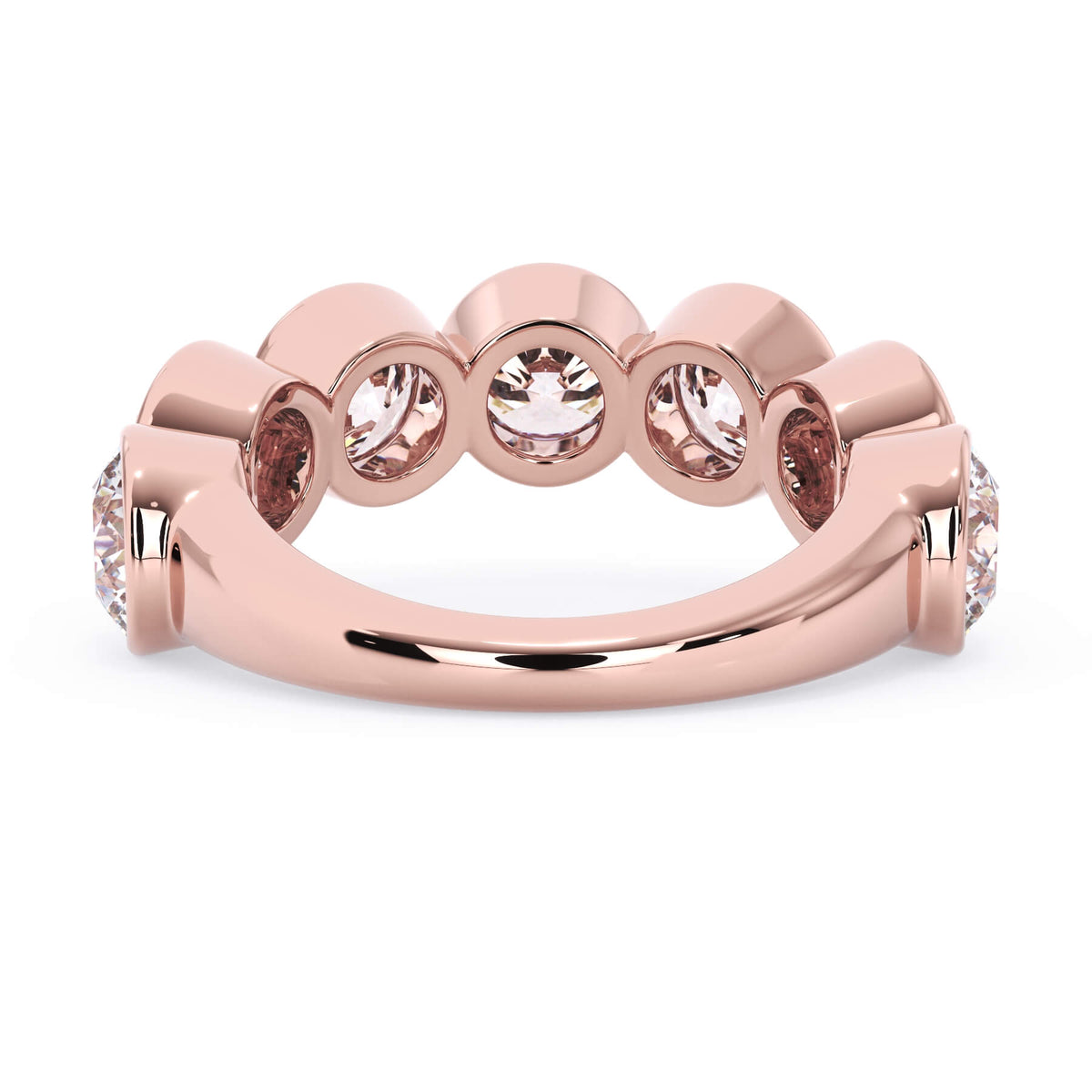 A picture of a seven stone diamond wedding ring with round diamonds that are bezel set in rose gold on a white background with a view of the underside of the ring.