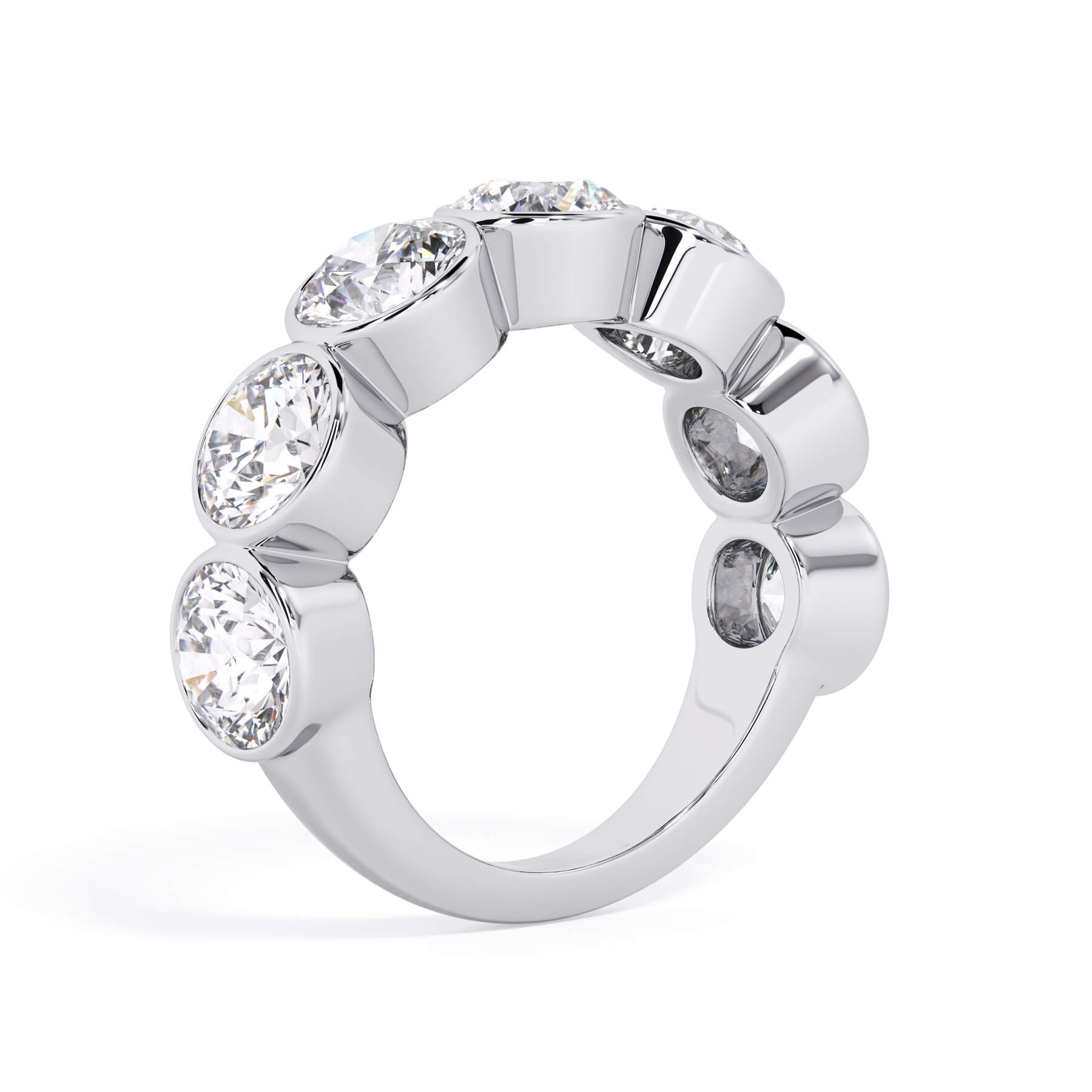 A picture of a seven stone diamond wedding ring with round diamonds that are bezel set in white gold or platinum on a white background with a slightly angled, through the finger view.