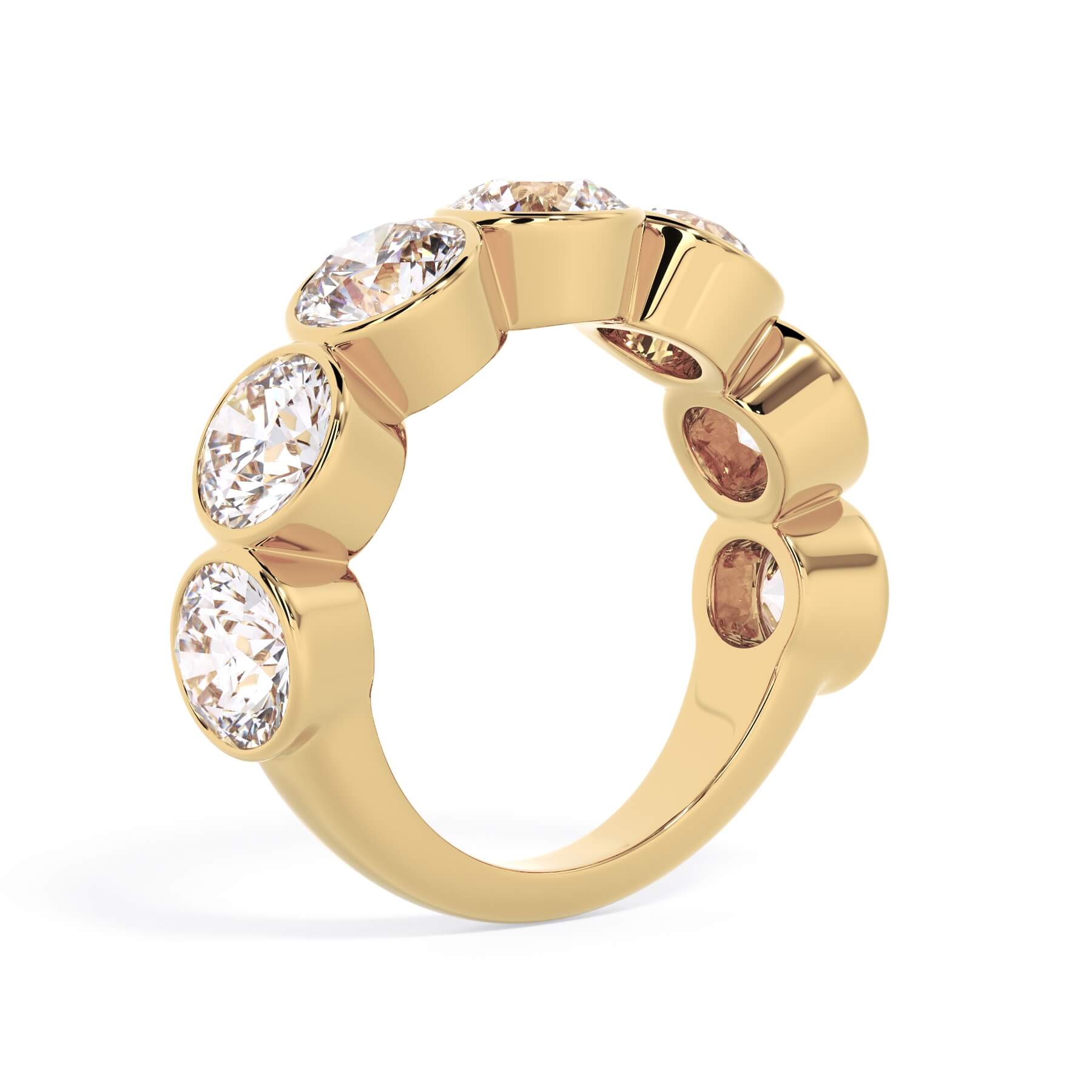 A picture of a seven stone diamond wedding ring with round diamonds that are bezel set in yellow gold on a white background with a slightly angled, through the finger view.