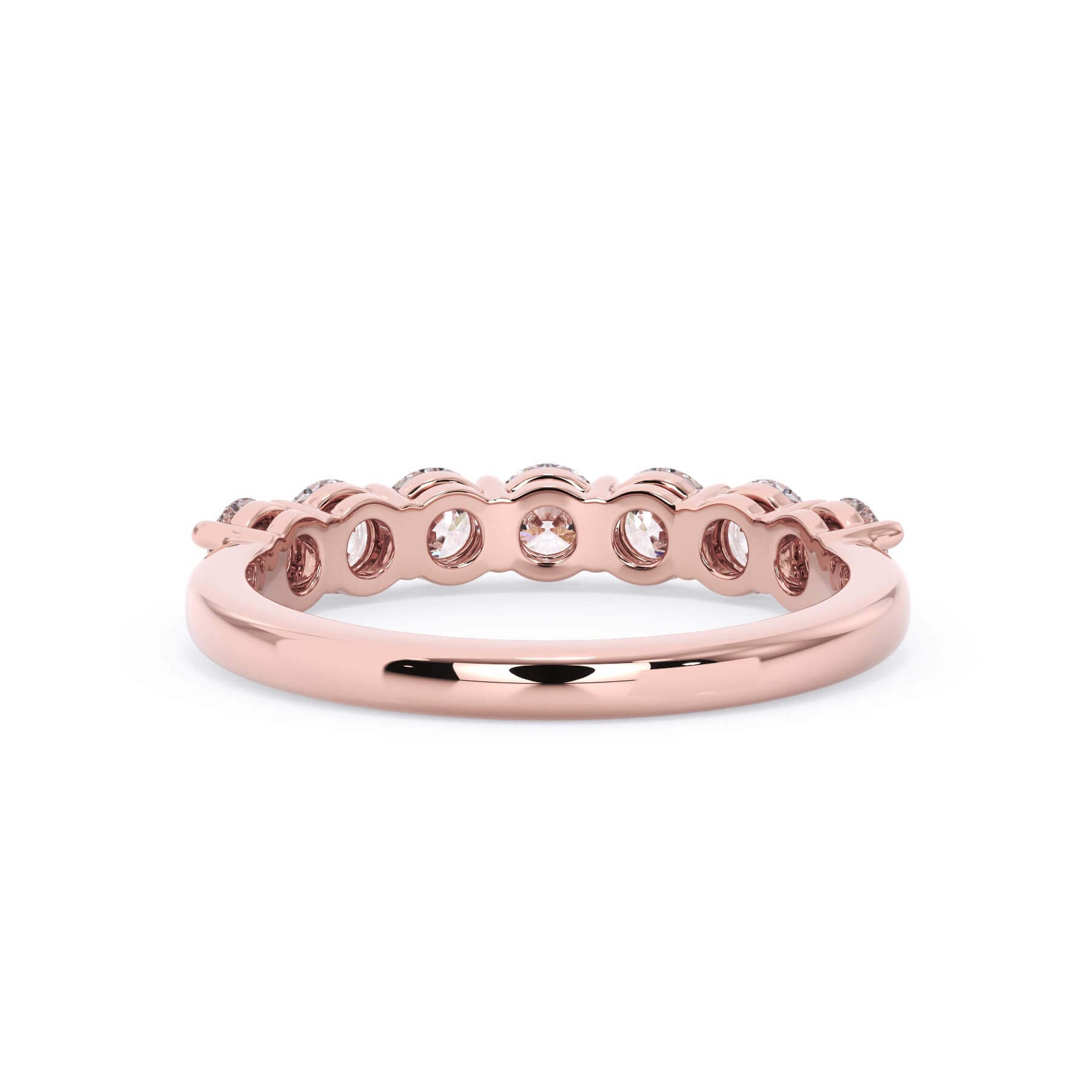 A picture of a seven stone diamond wedding ring with round diamonds that are shared prong set in rose gold on a white background with a view of the underside of the ring.