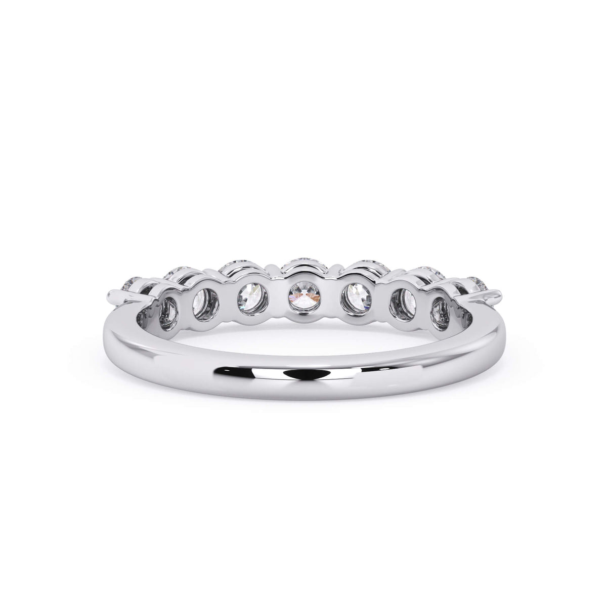 A picture of a seven stone diamond wedding ring with round diamonds that are shared prong set in white gold or platinum on a white background with a view of the underside of the ring.