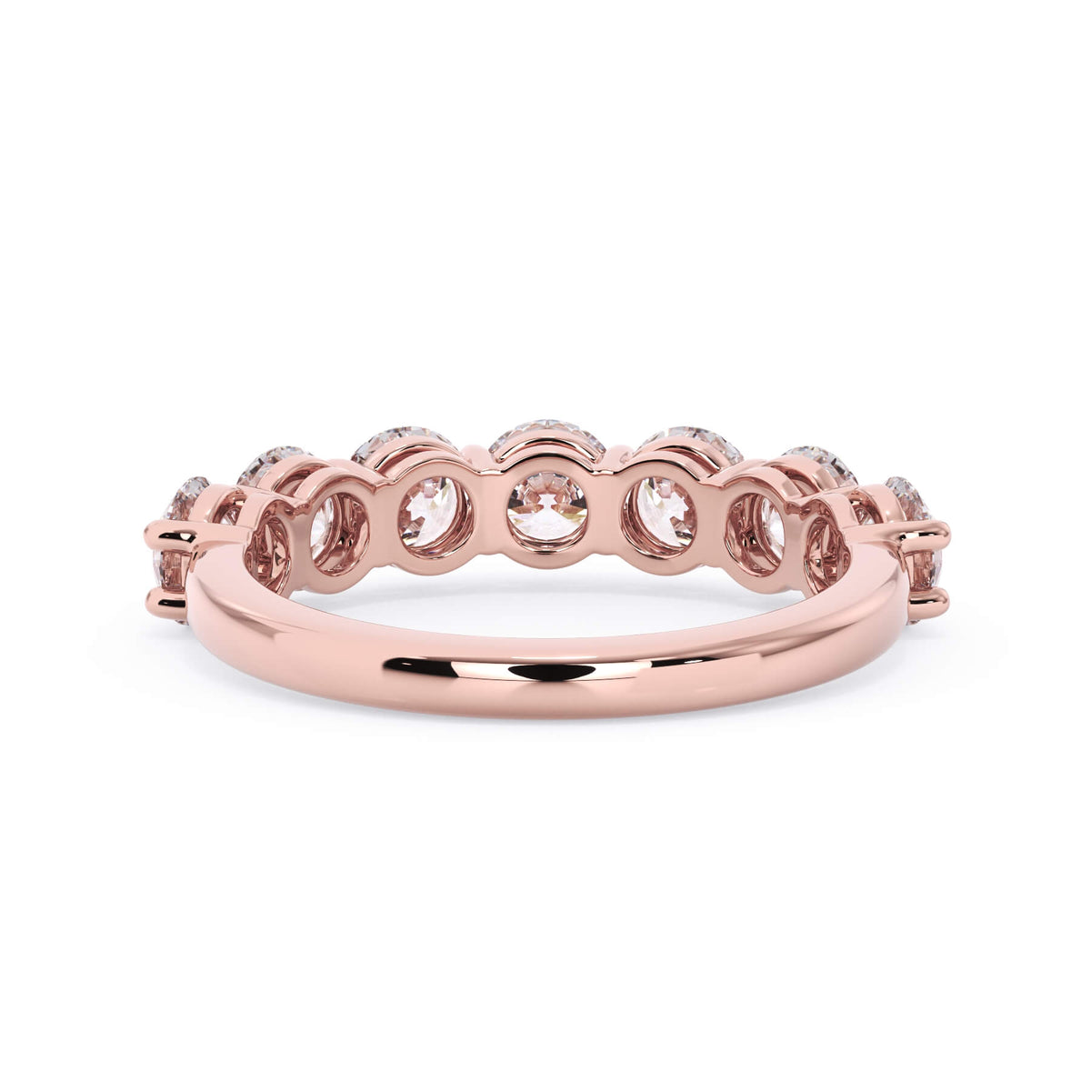A picture of a seven stone diamond wedding ring with round diamonds that are shared prong set in rose gold on a white background with a view of the underside of the ring.