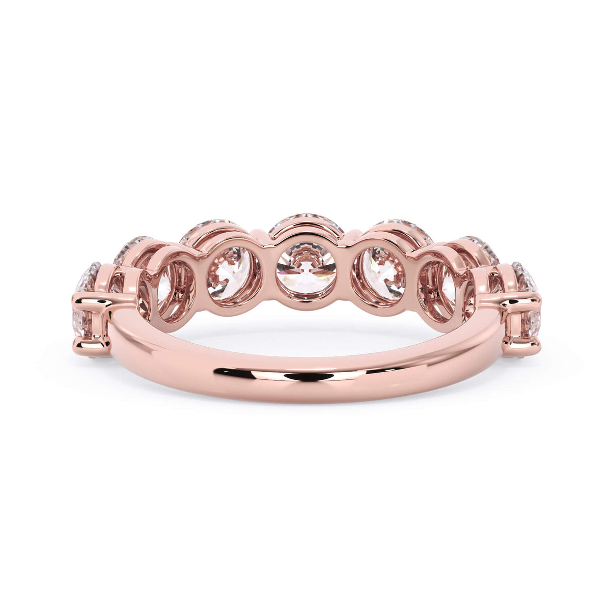 A picture of a seven stone diamond wedding ring with round diamonds that are shared prong set in rose gold on a white background with a view of the underside of the ring.