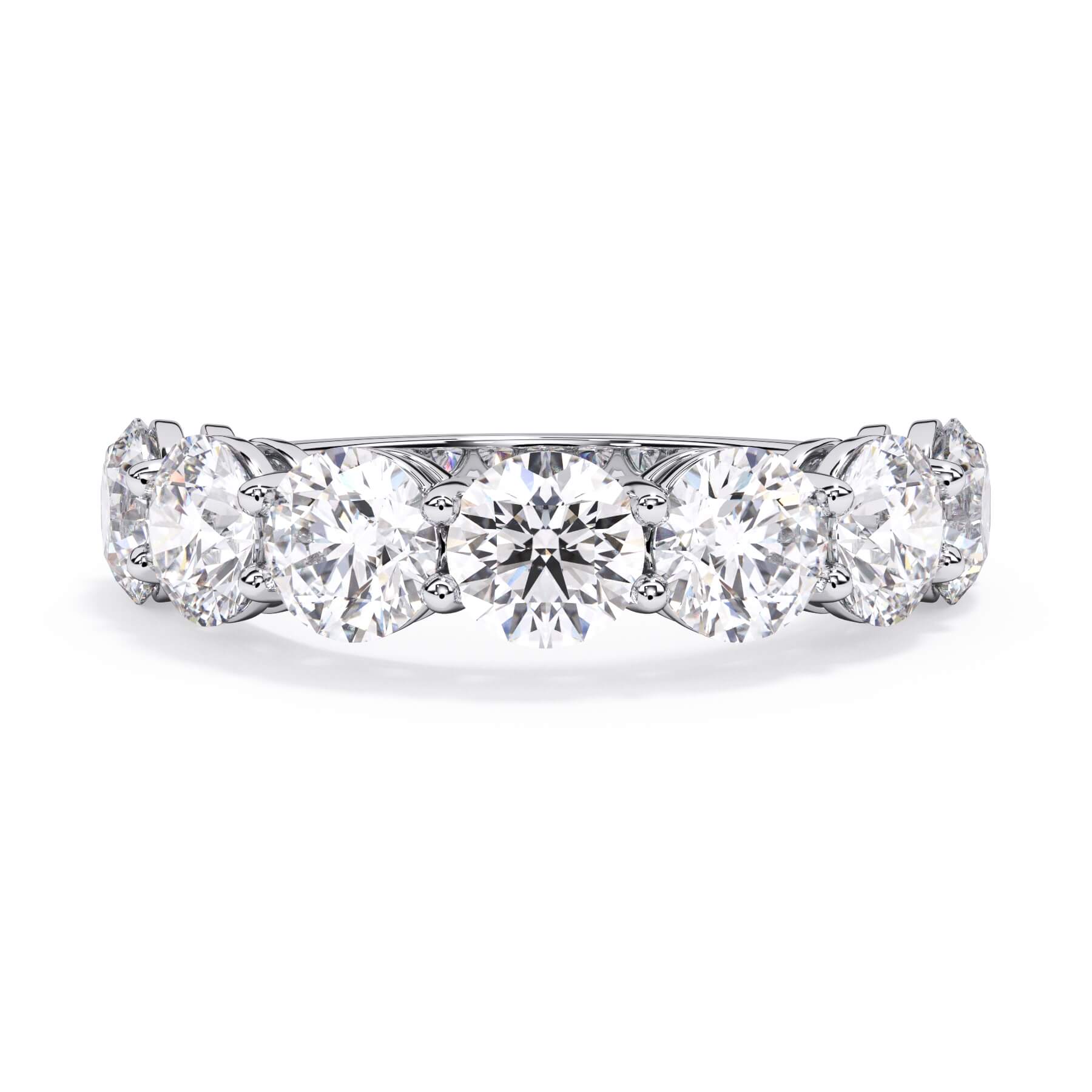 A picture of a seven stone diamond wedding ring with round diamonds that are shared prong set in white gold or platinum on a white background with the ring facing forward, lying down.