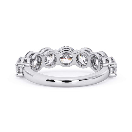 A picture of a seven stone diamond wedding ring with round diamonds that are shared prong set in white gold or platinum on a white background with a view of the underside of the ring.