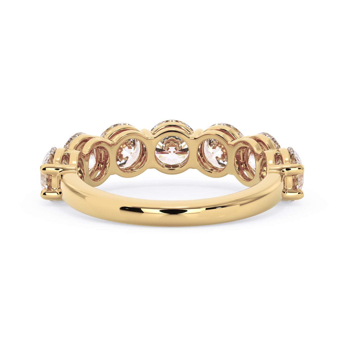 A picture of a seven stone diamond wedding ring with round diamonds that are shared prong set in yellow gold on a white background with a view of the underside of the ring.