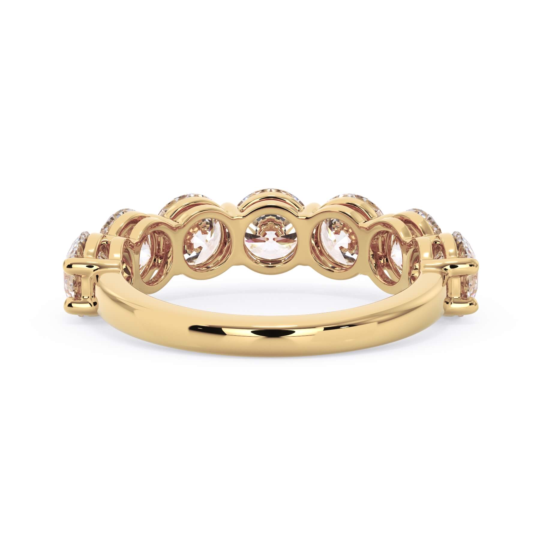 A picture of a seven stone diamond wedding ring with round diamonds that are shared prong set in yellow gold on a white background with a view of the underside of the ring.