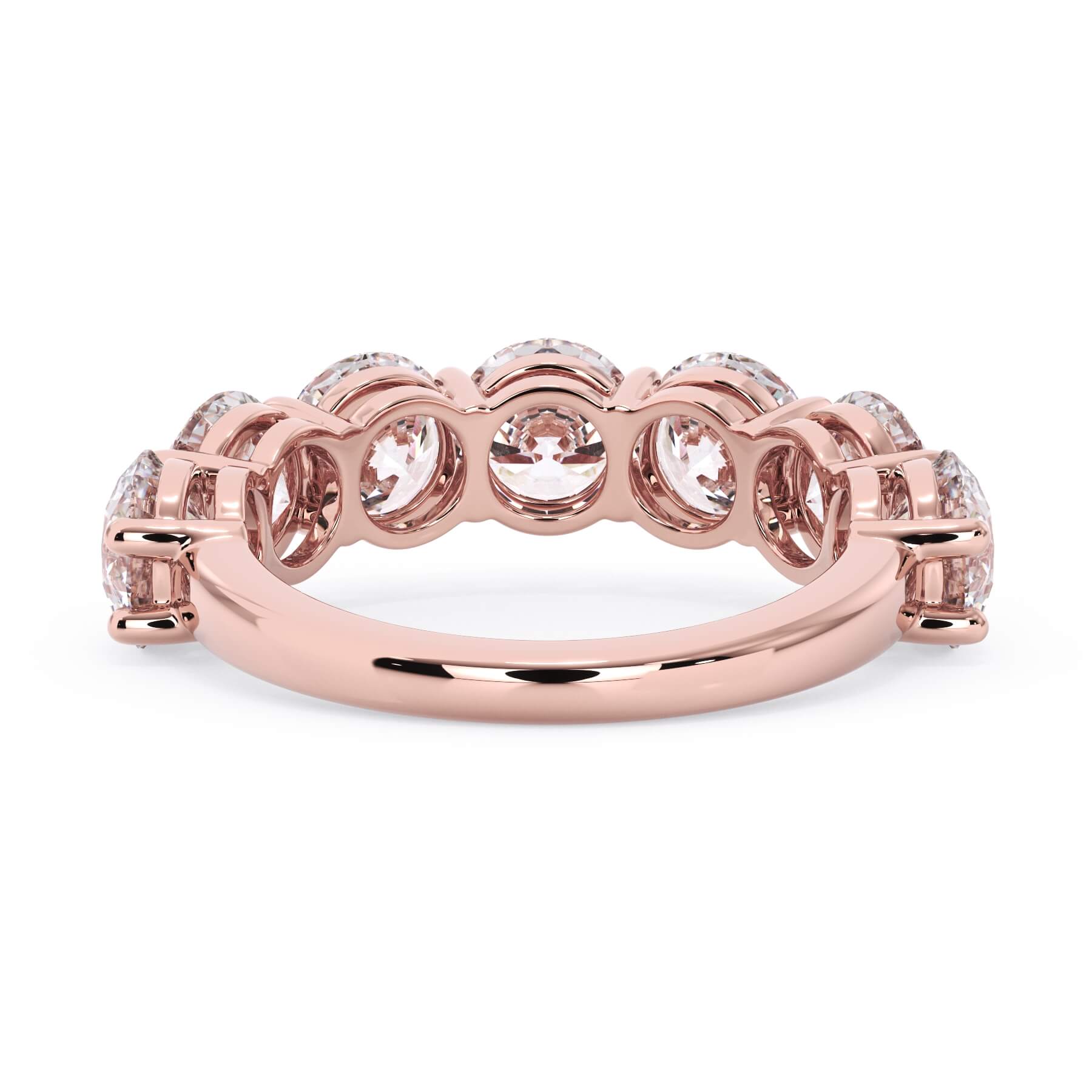 A picture of a seven stone diamond wedding ring with round diamonds that are shared prong set in rose gold on a white background with a view of the underside of the ring.