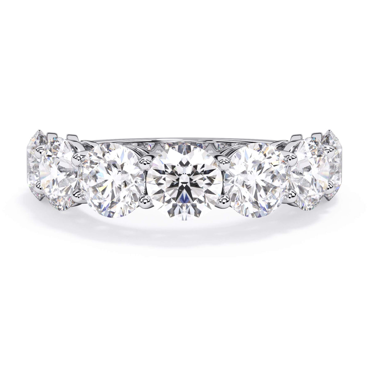 A picture of a seven stone diamond wedding ring with round diamonds that are shared prong set in white gold or platinum on a white background with the ring facing forward, lying down.