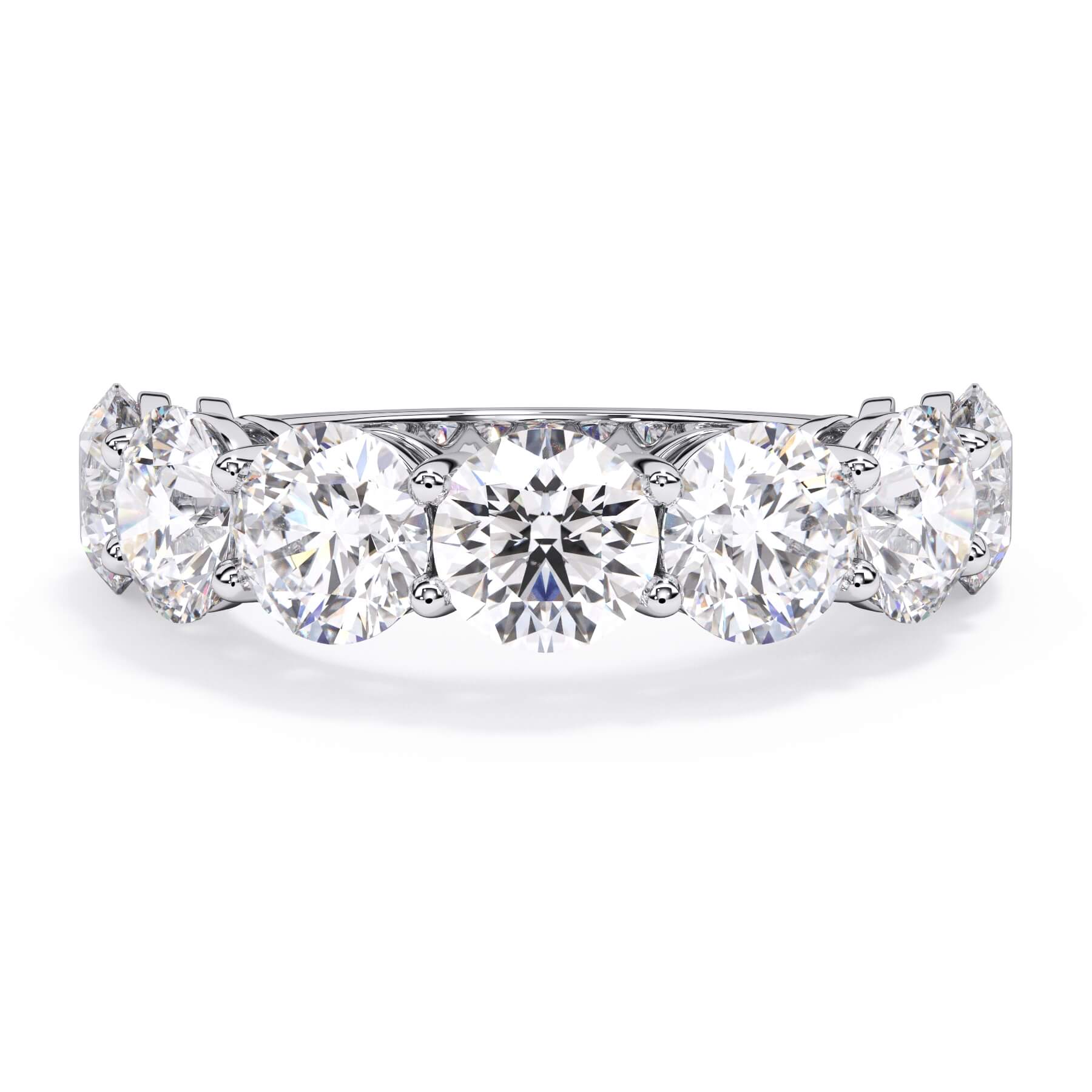 A picture of a seven stone diamond wedding ring with round diamonds that are shared prong set in white gold or platinum on a white background with the ring facing forward, lying down.