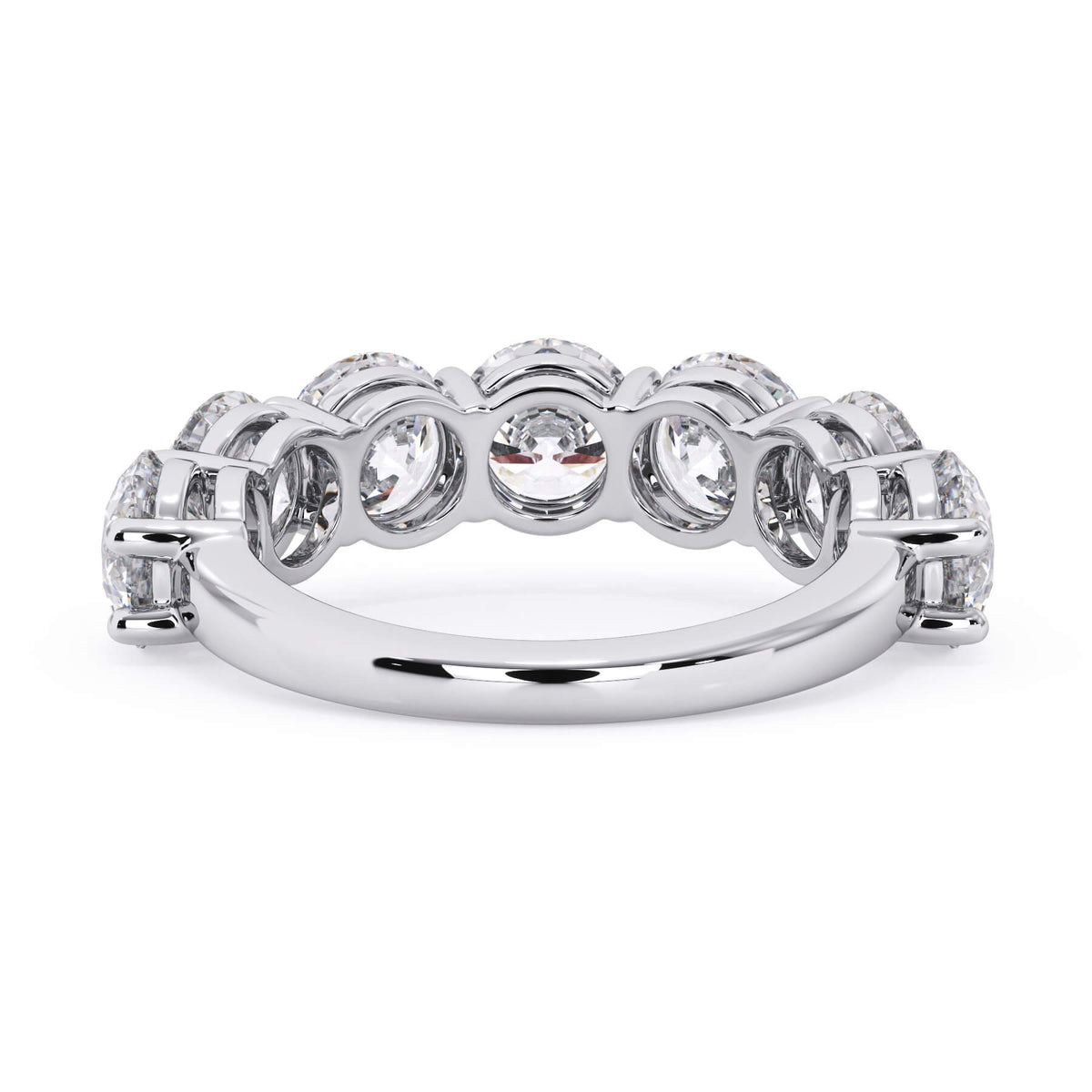 A picture of a seven stone diamond wedding ring with round diamonds that are shared prong set in white gold or platinum on a white background with a view of the underside of the ring.
