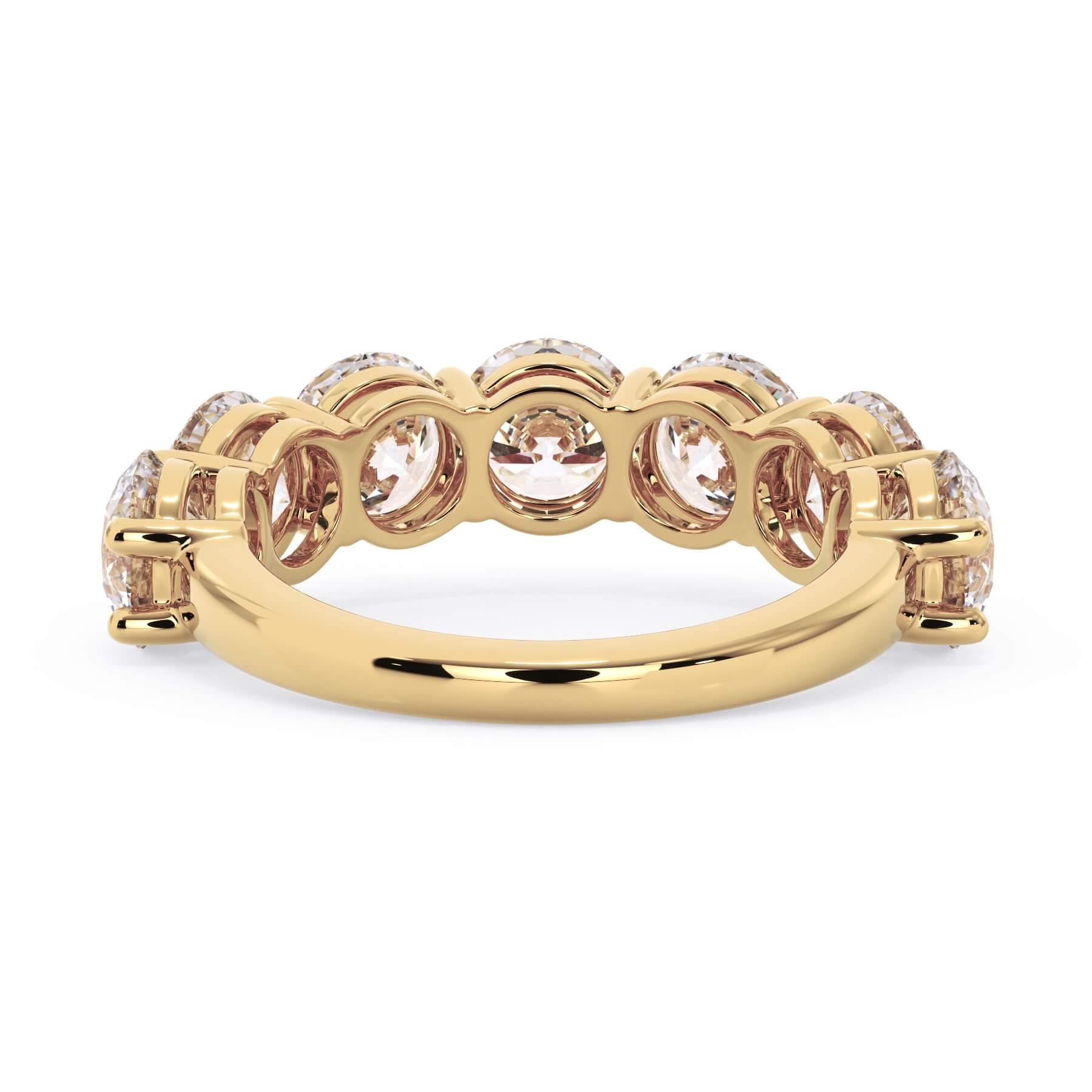 A picture of a seven stone diamond wedding ring with round diamonds that are shared prong set in yellow gold on a white background with a view of the underside of the ring.
