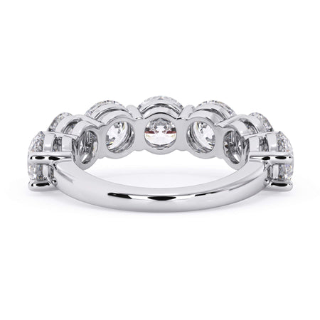 A picture of a seven stone diamond wedding ring with round diamonds that are shared prong set in white gold or platinum on a white background with a view of the underside of the ring.