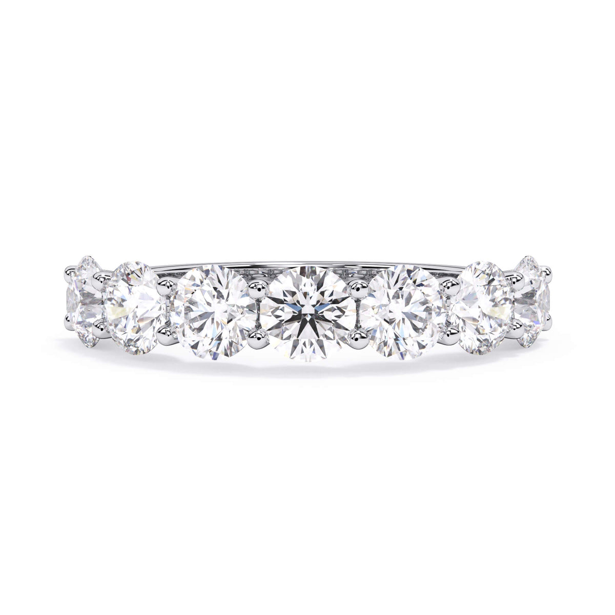 A picture of a seven stone diamond wedding ring with round diamonds that are U prong set in white gold or platinum on a white background with the ring facing forward, lying down.