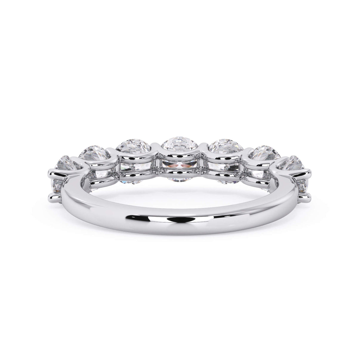 A picture of a seven stone diamond wedding ring with round diamonds that are U prong set in white gold or platinum on a white background with a view of the underside of the ring.