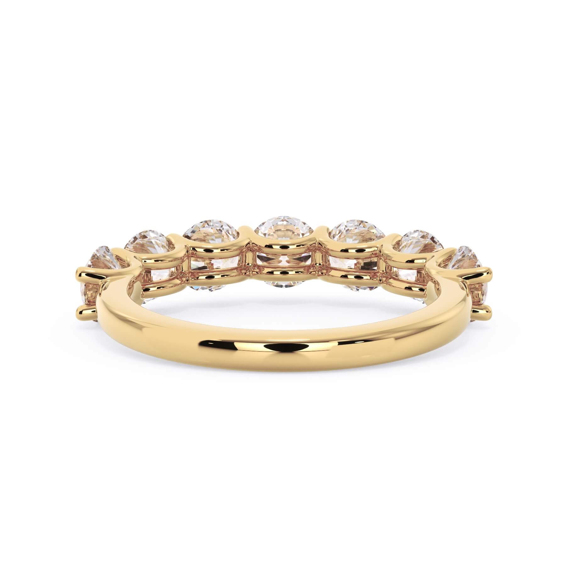 A picture of a seven stone diamond wedding ring with round diamonds that are U prong set in yellow gold on a white background with a view of the underside of the ring.