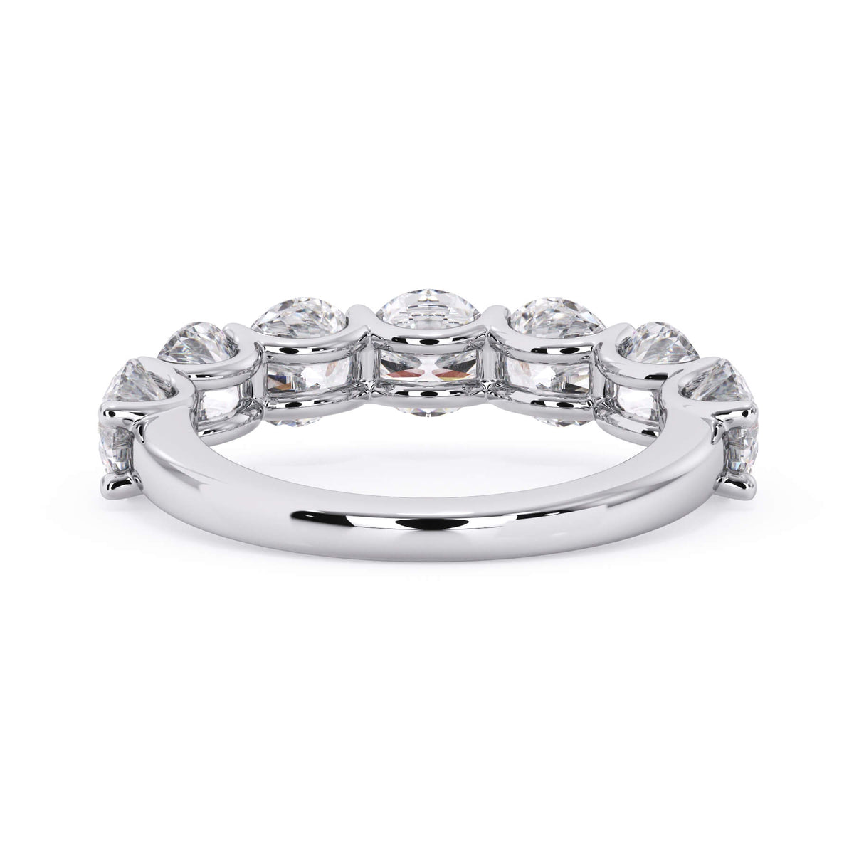 A picture of a seven stone diamond wedding ring with round diamonds that are U prong set in white gold or platinum on a white background with a view of the underside of the ring.