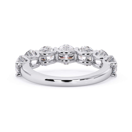 A picture of a seven stone diamond wedding ring with round diamonds that are U prong set in white gold or platinum on a white background with a view of the underside of the ring.
