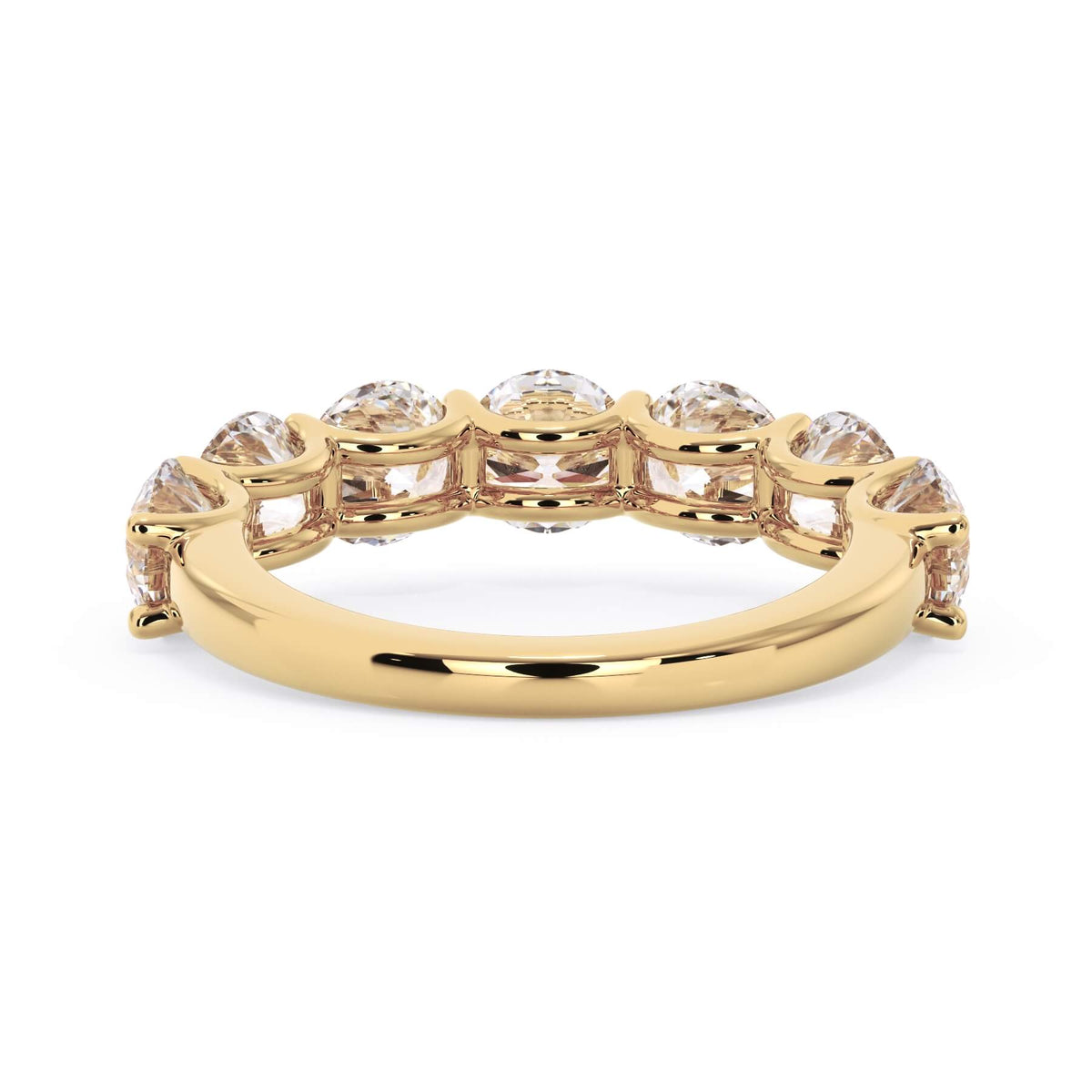 A picture of a seven stone diamond wedding ring with round diamonds that are U prong set in yellow gold on a white background with a view of the underside of the ring.