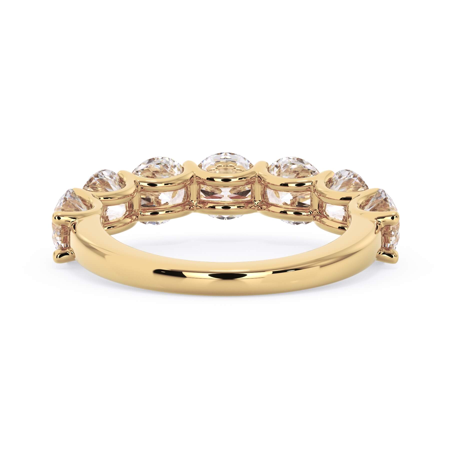 A picture of a seven stone diamond wedding ring with round diamonds that are U prong set in yellow gold on a white background with a view of the underside of the ring.