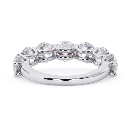 A picture of a seven stone diamond wedding ring with round diamonds that are U prong set in white gold or platinum on a white background with a view of the underside of the ring.