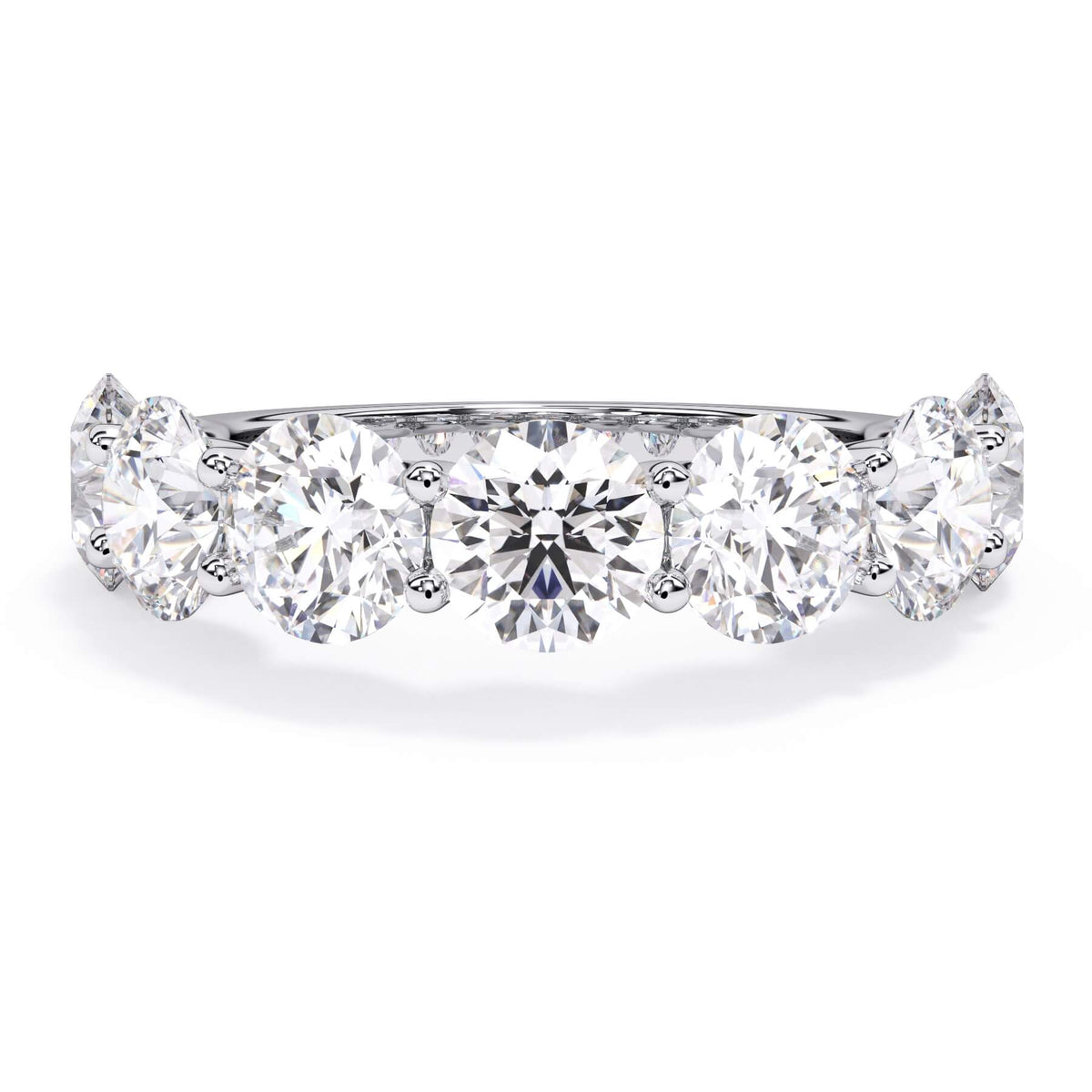 A picture of a seven stone diamond wedding ring with round diamonds that are U prong set in white gold or platinum on a white background with the ring facing forward, lying down.