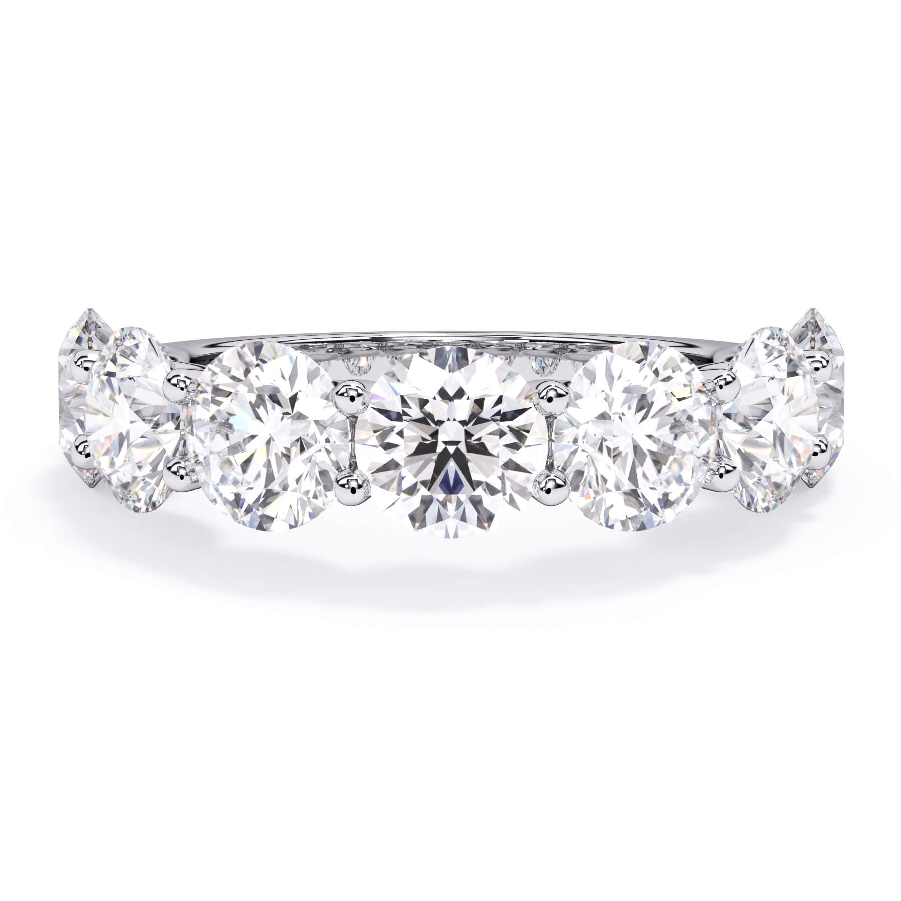 A picture of a seven stone diamond wedding ring with round diamonds that are U prong set in white gold or platinum on a white background with the ring facing forward, lying down.