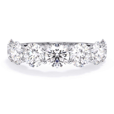 A picture of a seven stone diamond wedding ring with round diamonds that are U prong set in white gold or platinum on a white background with the ring facing forward, lying down.
