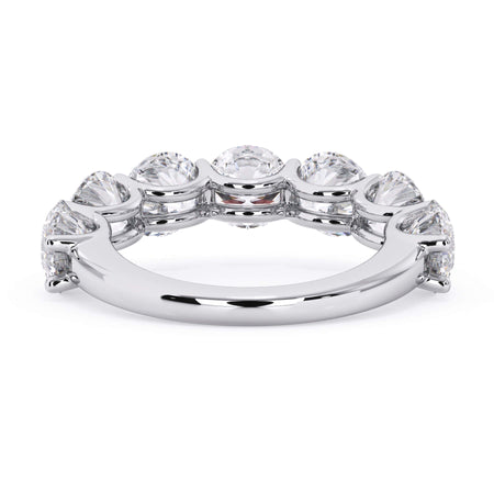 A picture of a seven stone diamond wedding ring with round diamonds that are U prong set in white gold or platinum on a white background with a view of the underside of the ring.
