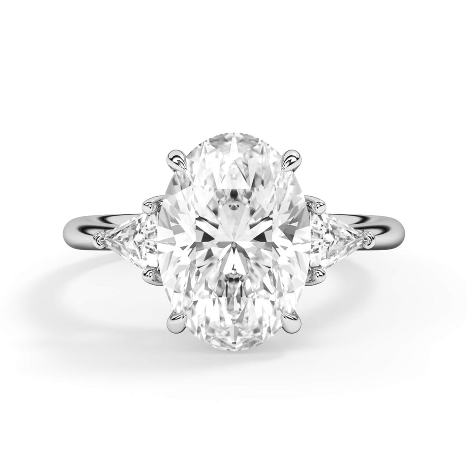 Classic Three Stone Engagement Ring with Trillion Diamonds (SKU: HE10197) Shown with Oval Shape Diamond in White Gold or Platinum - Front View