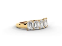A video of a five stone diamond wedding ring that changes in color from white metal, to yellow, to rose gold on a white background.