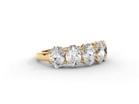 A video of a five stone diamond wedding ring that changes in color from white metal, to yellow, to rose gold on a white background.