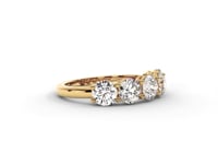 A video of a five stone diamond wedding ring that changes in color from white metal, to yellow, to rose gold on a white background.