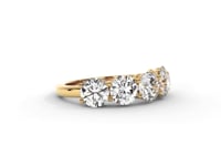 A video of a five stone diamond wedding ring that changes in color from white metal, to yellow, to rose gold on a white background.