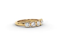 A video of a five stone diamond wedding ring that changes in color from white metal, to yellow, to rose gold on a white background.