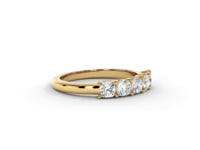 A video of a five stone diamond wedding ring that changes in color from white metal, to yellow, to rose gold on a white background.