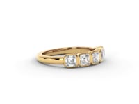 A video of a five stone diamond wedding ring that changes in color from white metal, to yellow, to rose gold on a white background.