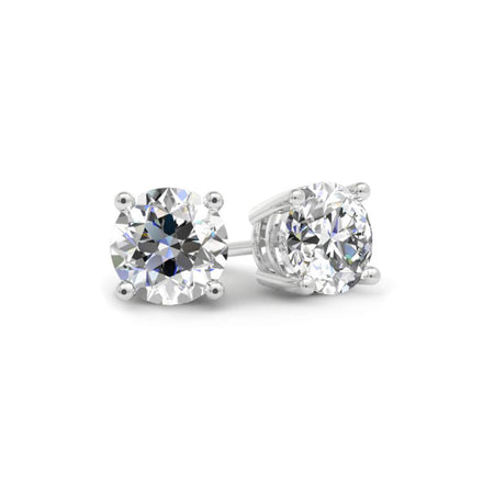 Pair of diamond stud earrings on a white background